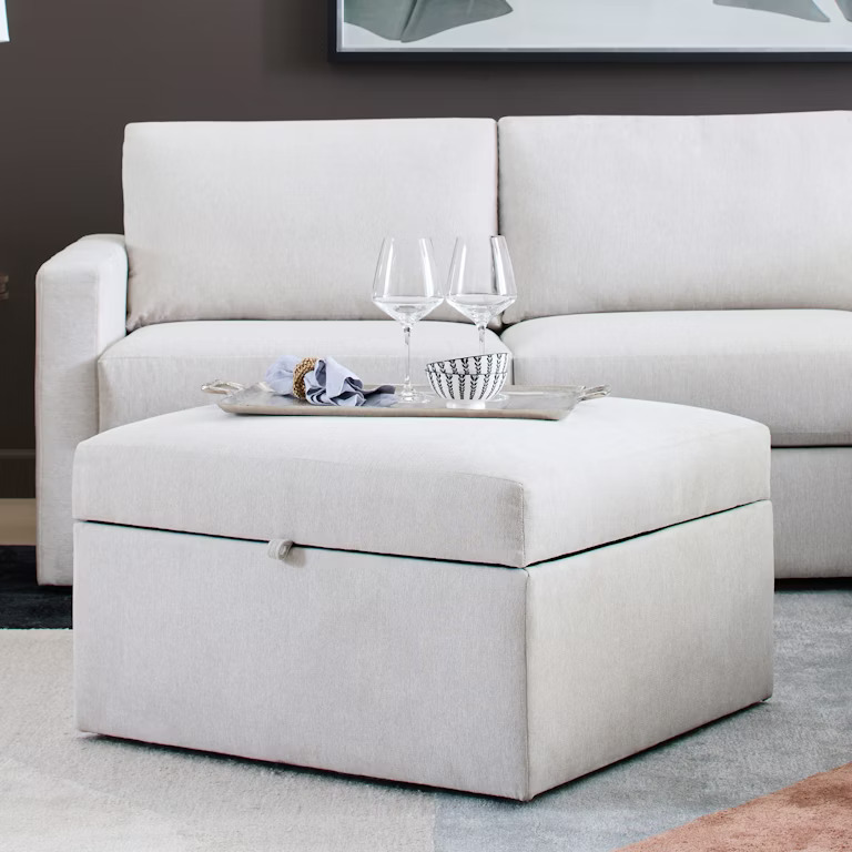 This ottoman offers hidden storage and a sleek design. It’s perfect for keeping your living room organized while doubling as a functional surface or extra seating.